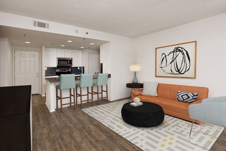 Renovated Package III kitchen with grey quartz countertops, blue tile backsplash, white cabinetry, stainless steel appliances, and hard surface plank flooring