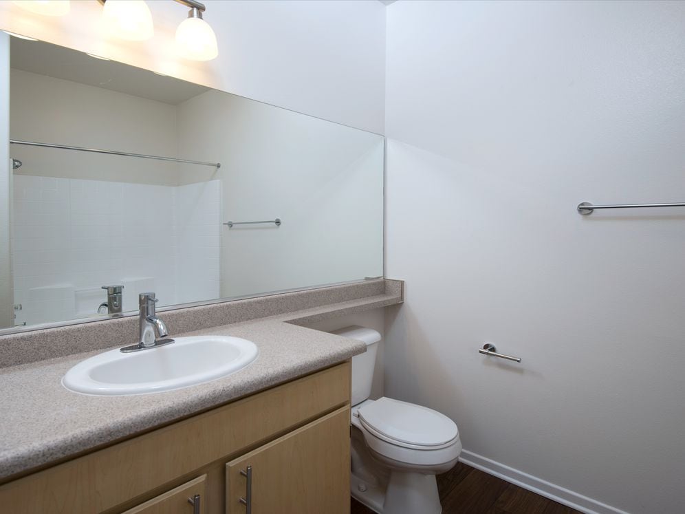Bath with laminate countertops, oak cabinetry, and hard surface flooring