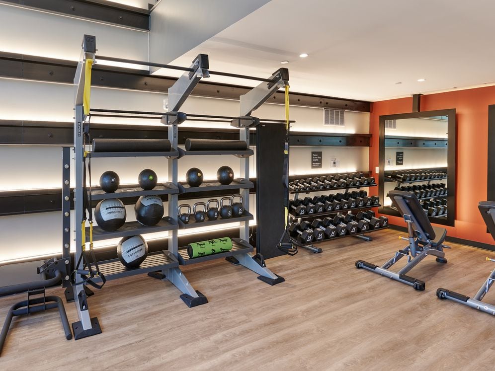 Upper level fitness center with squat rack and other weight machines