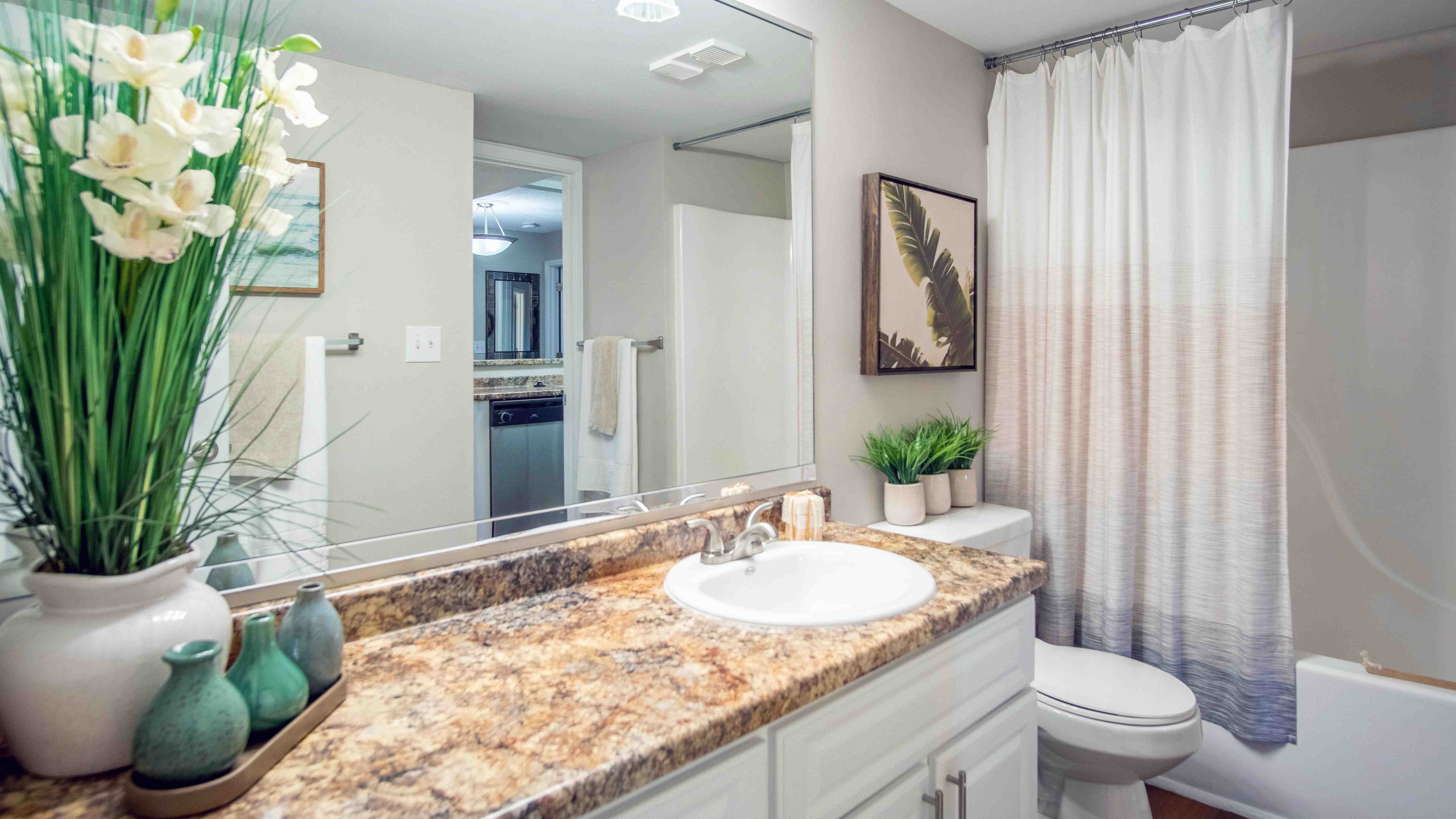 Feel like royalty in our spacious ensuite bathrooms adorned with expansive granite-inspired countertops and illuminating vanity lighting. 