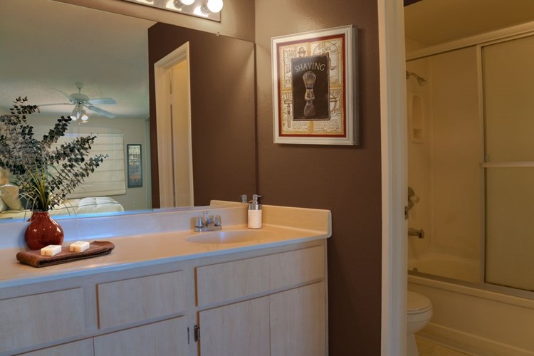 Classic Package I bath with oak cabinetry, white laminate countertops, and hard surface flooring