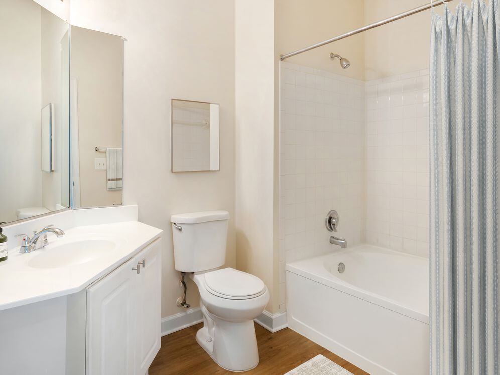 Classic II bath with white cabinetry, white laminate countertops, and hard surface flooring