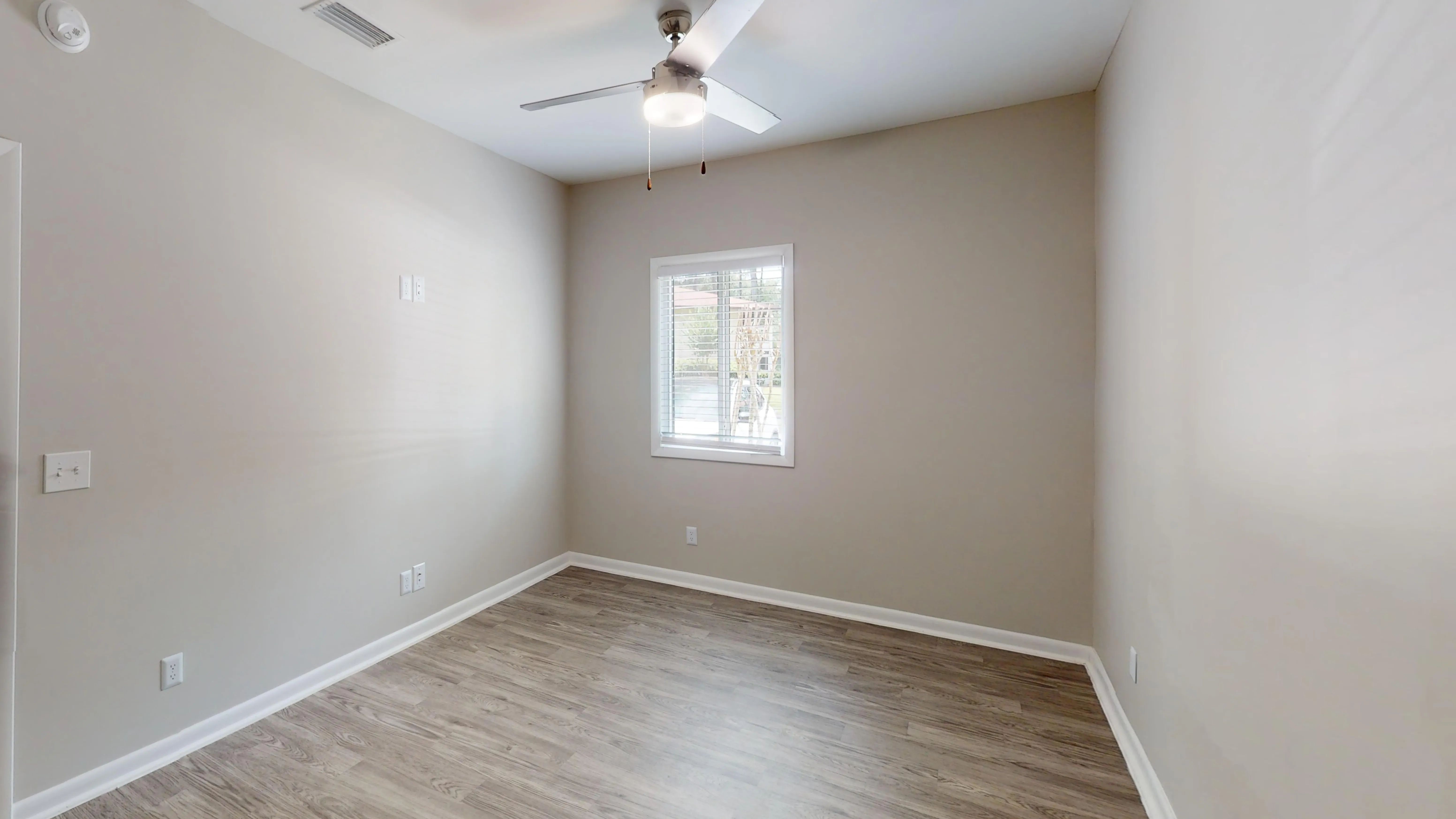 The Rosewood floor plan features wood-style flooring, a contemporary ceiling fan, and abundant natural light, creating a relaxing retreat to start and end your day.