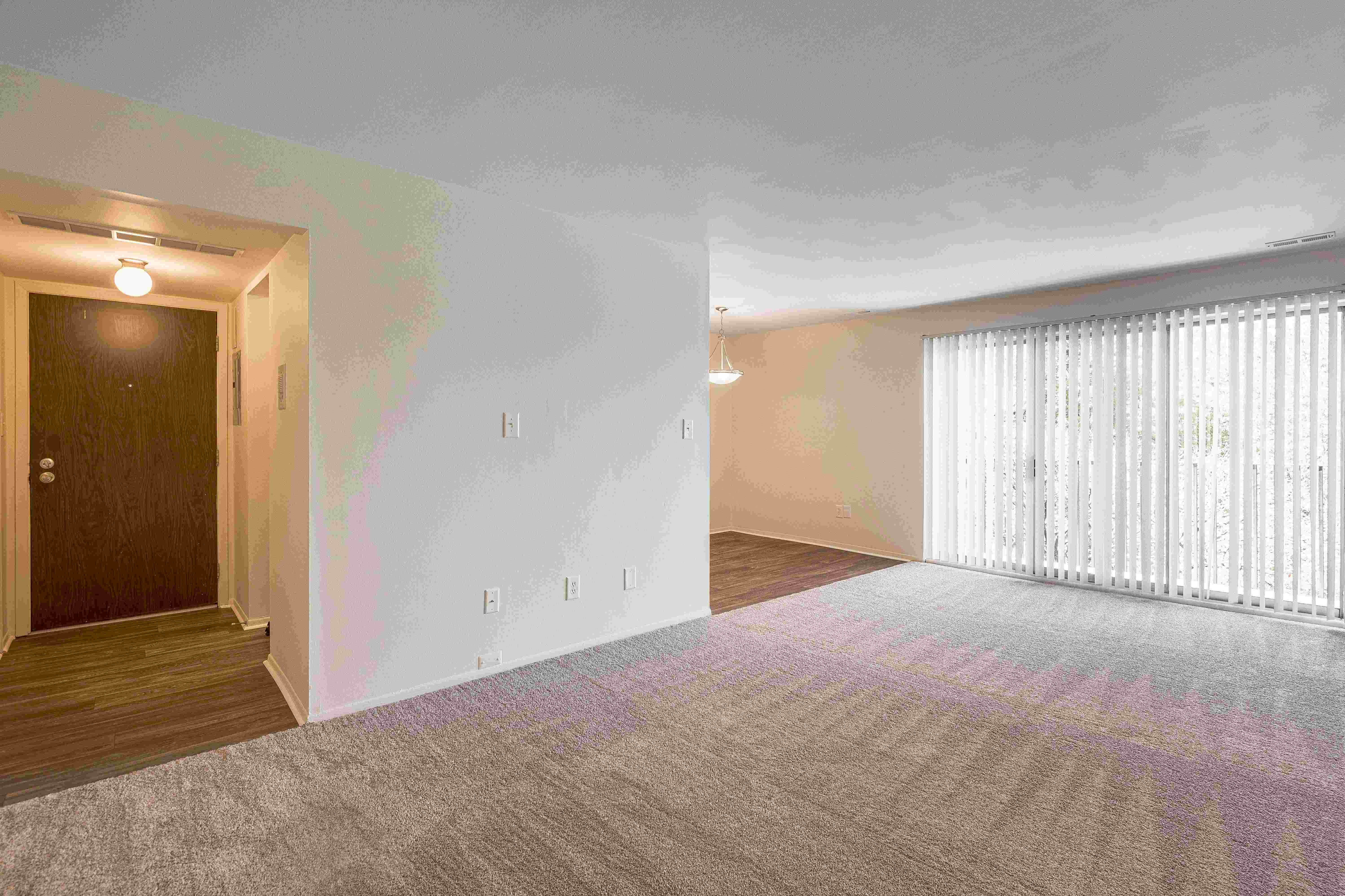 Open and airy entry way and living room at Knottingham Apartments in Clinton Township, M