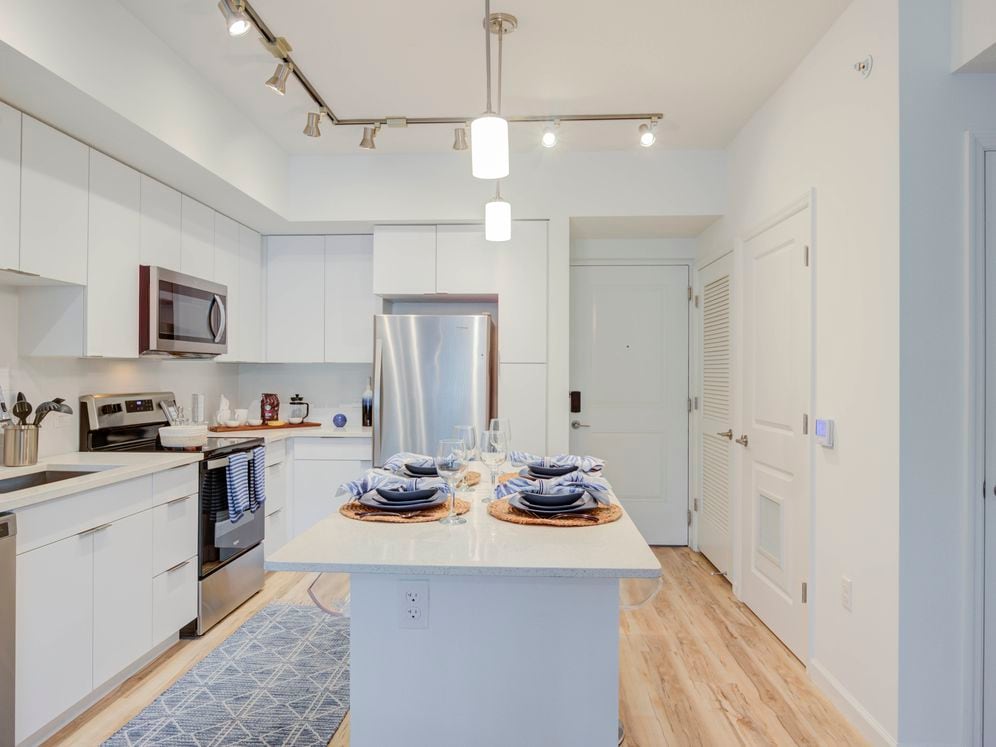 East Phase Kitchen with white cabinetry, white countertops, stainless steel appliances, and hard surface flooring