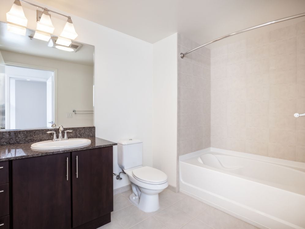 Classic Phase III bath with granite countertops and espresso cabinetry