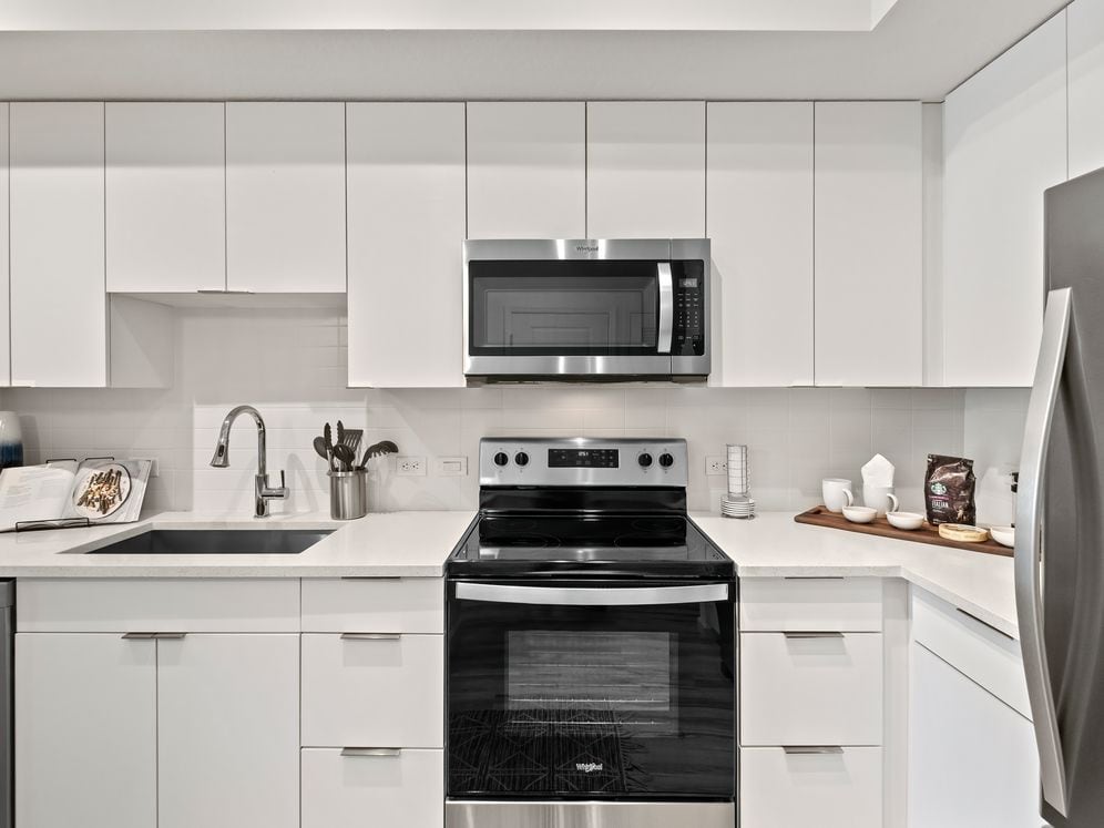 East Phase Kitchen with white cabinetry, white countertops, and stainless steel appliances