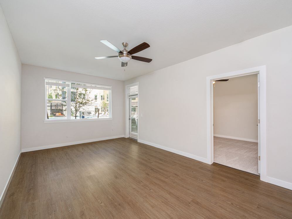 Finish Package I Living area with hard-surface vinyl plank flooring and ceiling fan