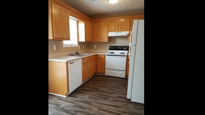 Kitchen features dishwasher, electric stove and refrigerator 