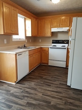 Kitchen features dishwasher, electric stove and refrigerator 