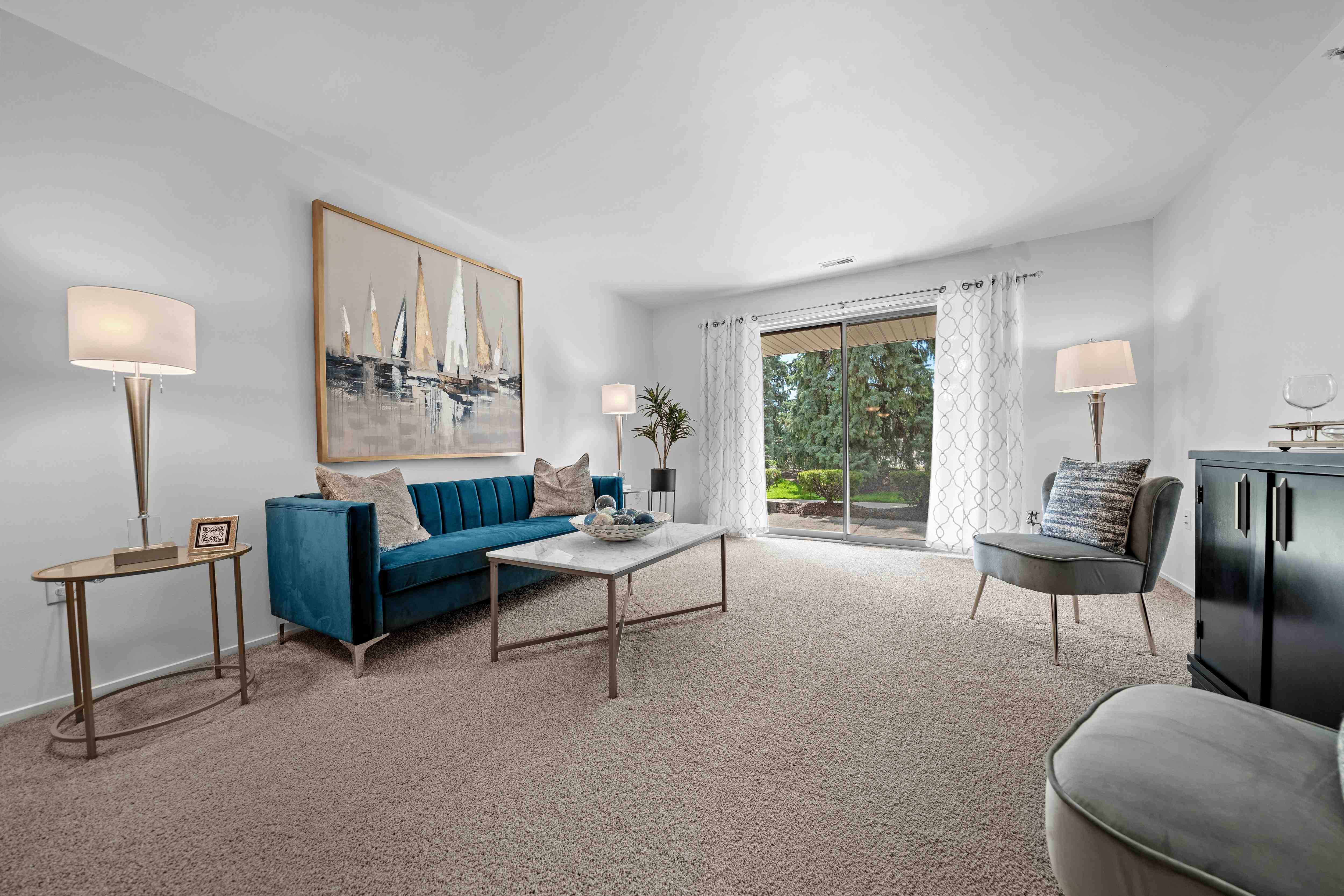 Spacious Living room with patio at Prentiss Pointe Apartments in Harrison Township