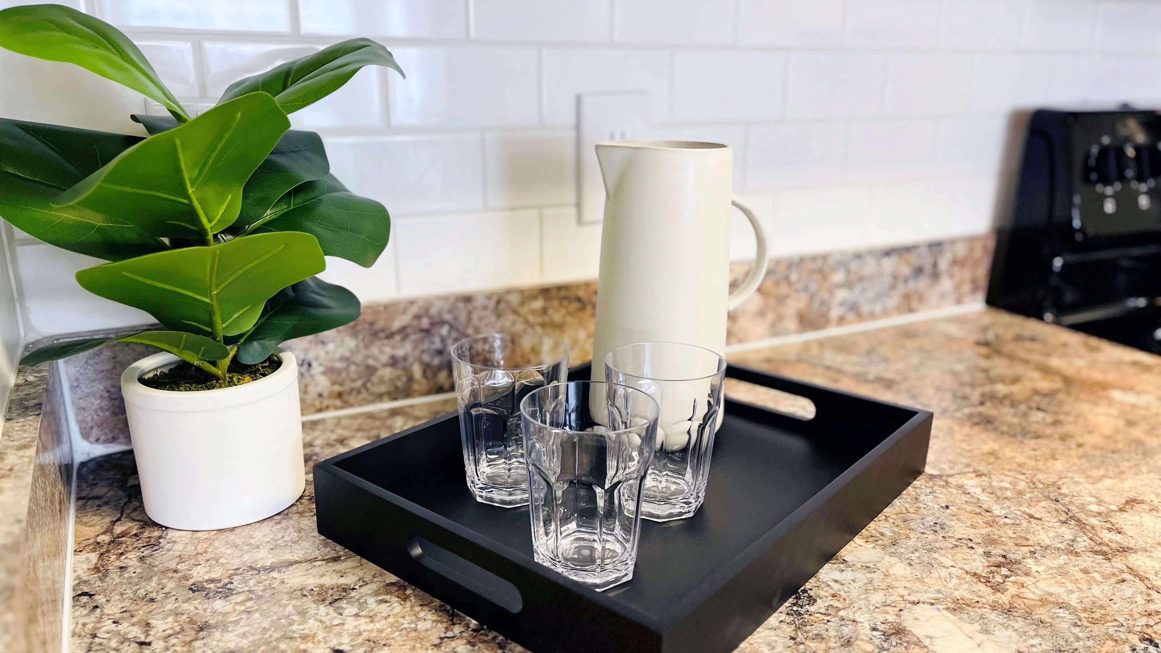 Experience kitchen design at its best with subway tile backsplash and granite-style countertops, inspiring your culinary creativity.