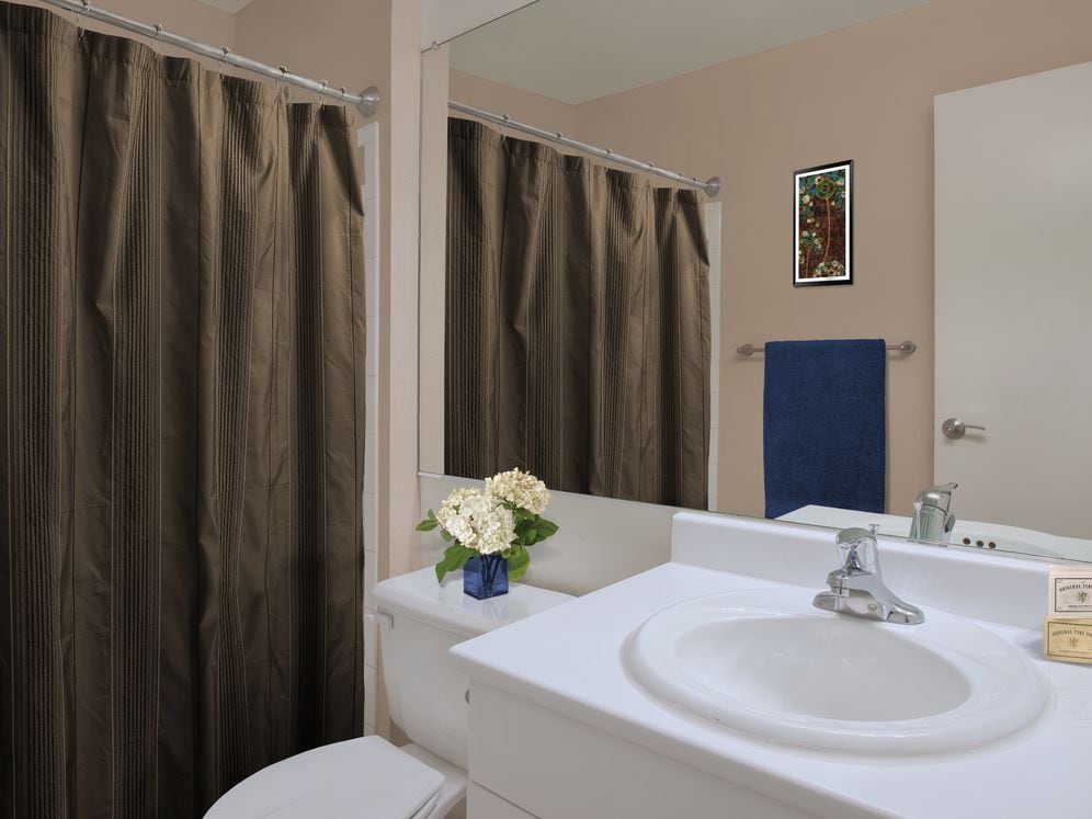 Classic Package bath with white cabinetry, laminate countertops, and hard surface flooring