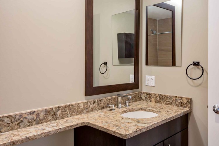 Bathrooms with upgraded finishes and glass showers in select homes