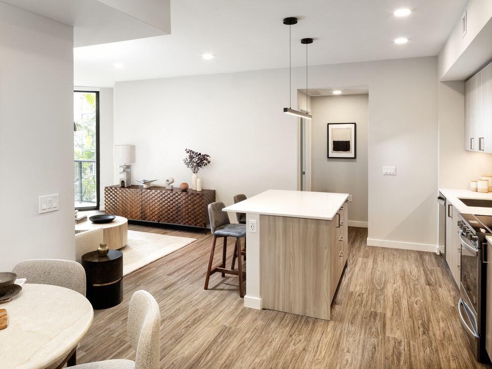 Upgrade Collection I kitchen with light wood cabinetry, white quartz countertops, and stainless steel appliances