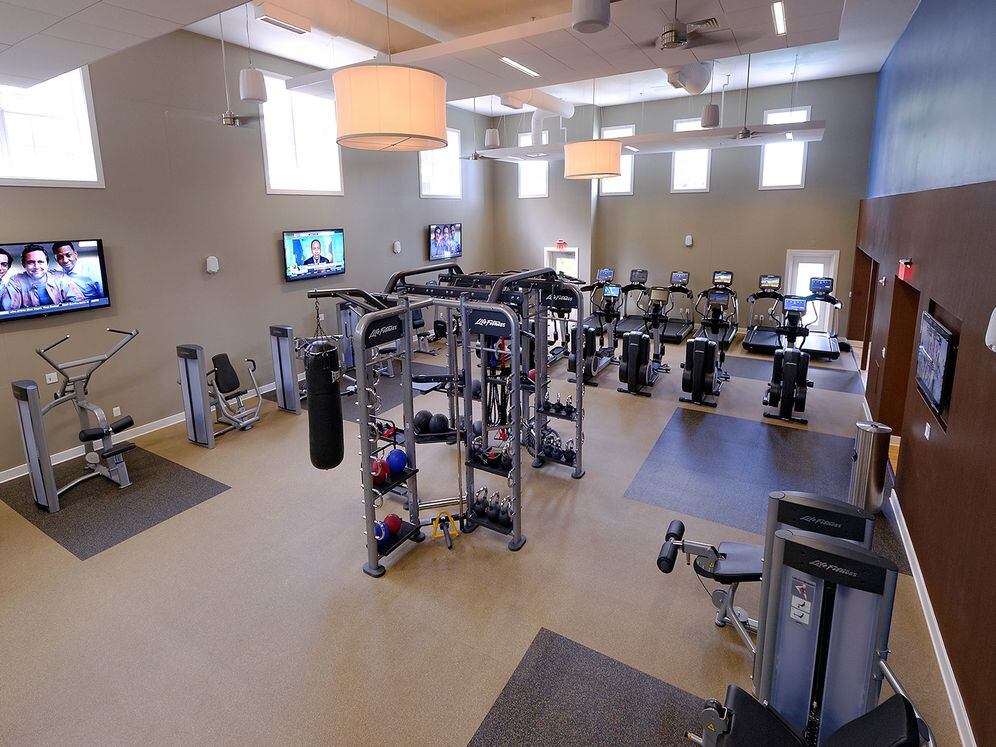 Fitness center with strength training equipment, cardio equipment and flatscreen televisions
