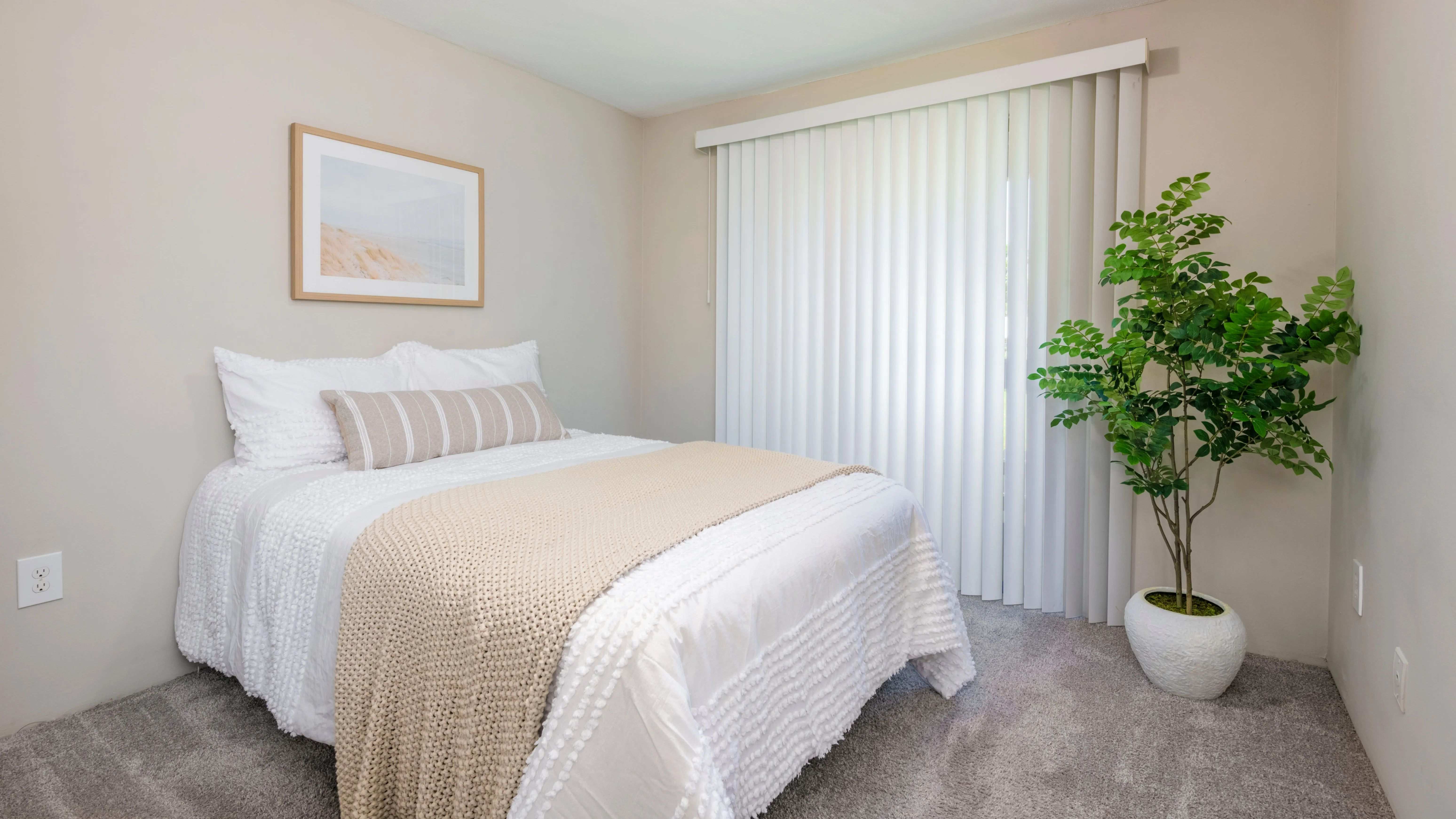Embrace the sun's warmth with a large slider leading to your private patio in our spacious bedrooms with plush carpeting and wood-style blinds.