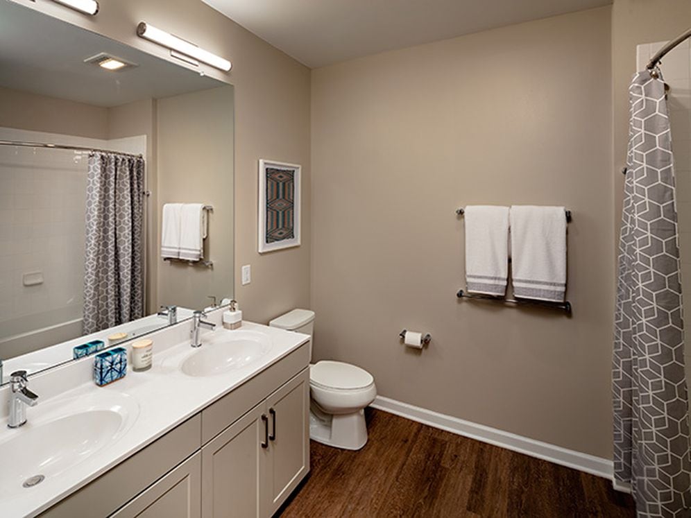 Bath with grey cabinetry, white quartz countertop, and hard surface flooring