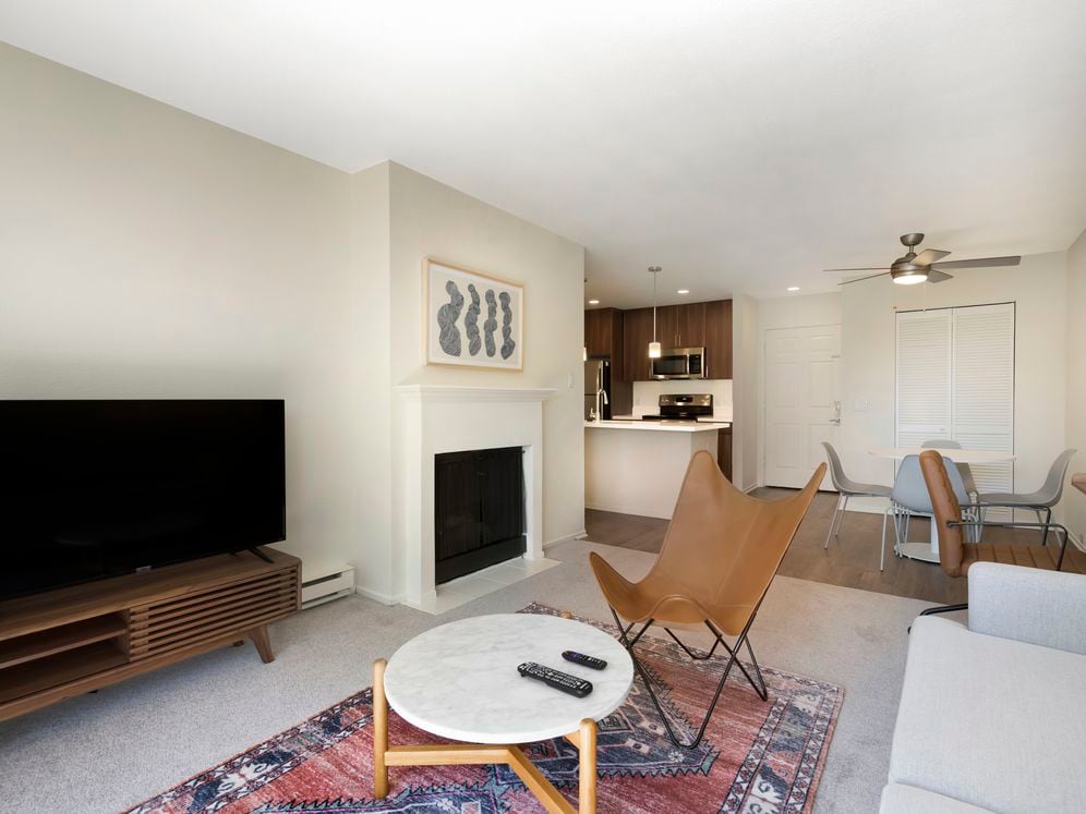 Furnished+ apartment homes come outfitted with a sofa, side chair, coffee table, TV stand and 50" Television (Representative Image – exact items and style of furnishings may vary)