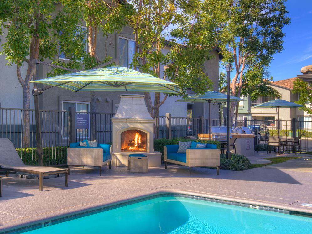 Swimming Pool With Lounge Seating And Fireplace