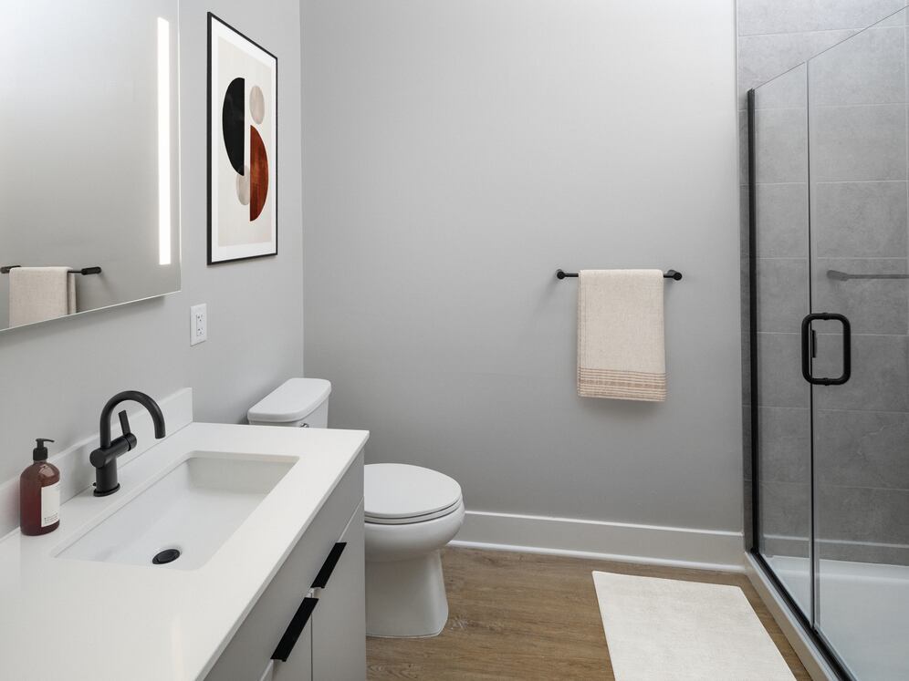 Signature Collection bath with LED vanity mirror, white quartz countertop, light grey cabinetry, walk-in shower, and hard-surface flooring