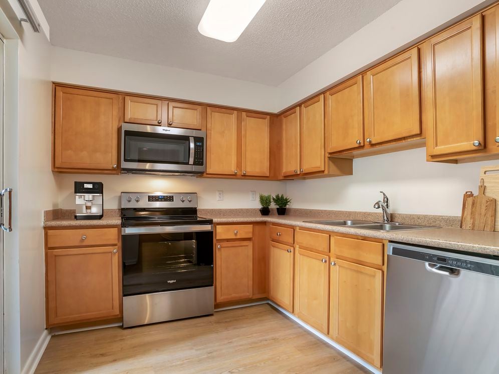 Upgraded Package I kitchen with oak cabinetry, beige laminate countertops, stainless steel appliances and hard surface flooring