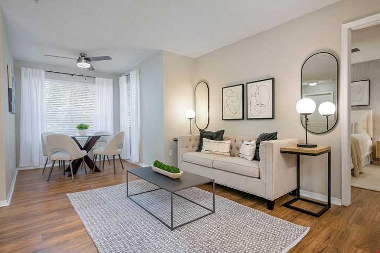 Spacious living rooms featuring wood-style flooring and a dining nook.