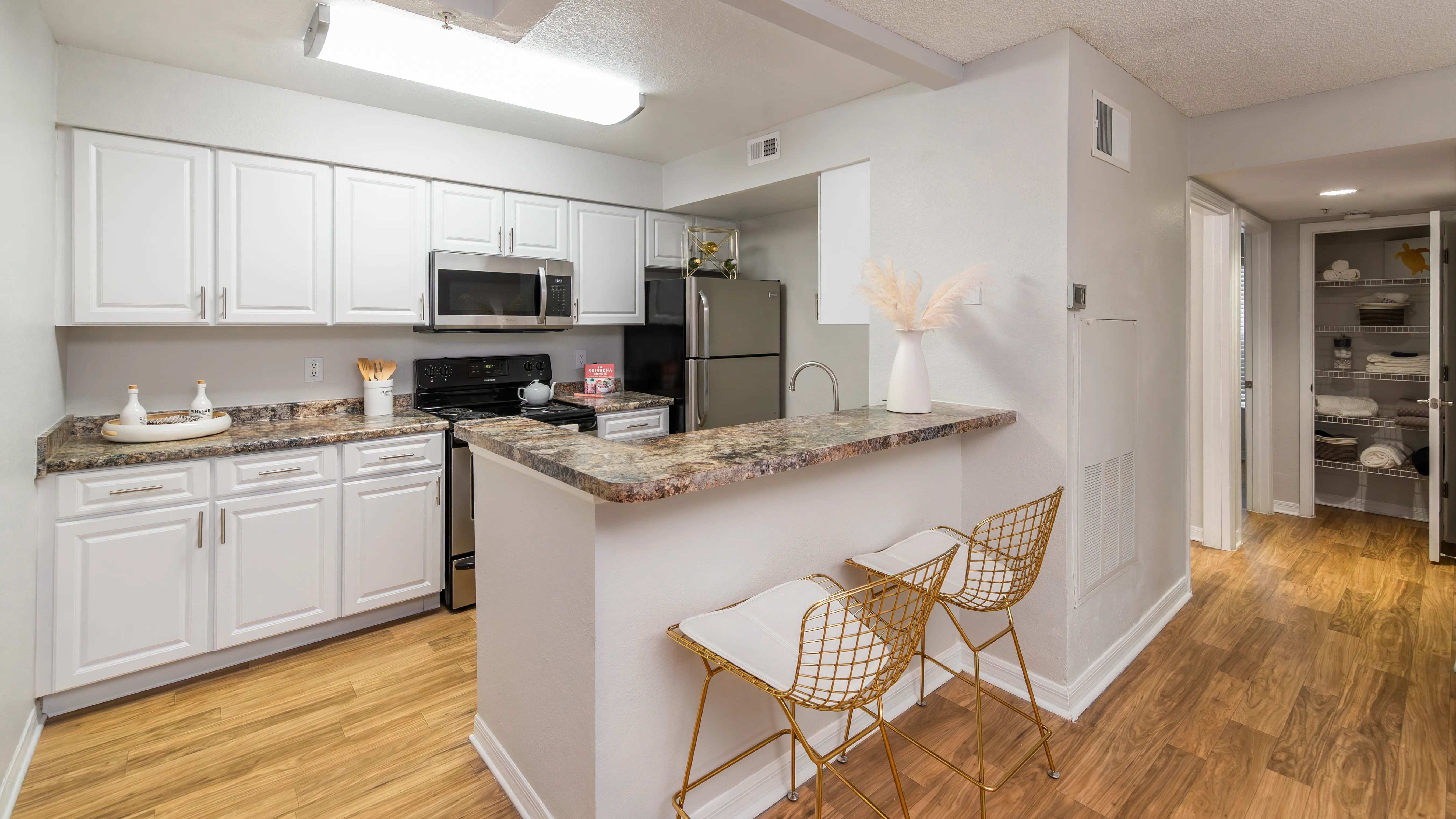 Enjoy a clean, modern kitchen featuring stainless steel appliances, ample cabinet space, and a cozy breakfast bar.