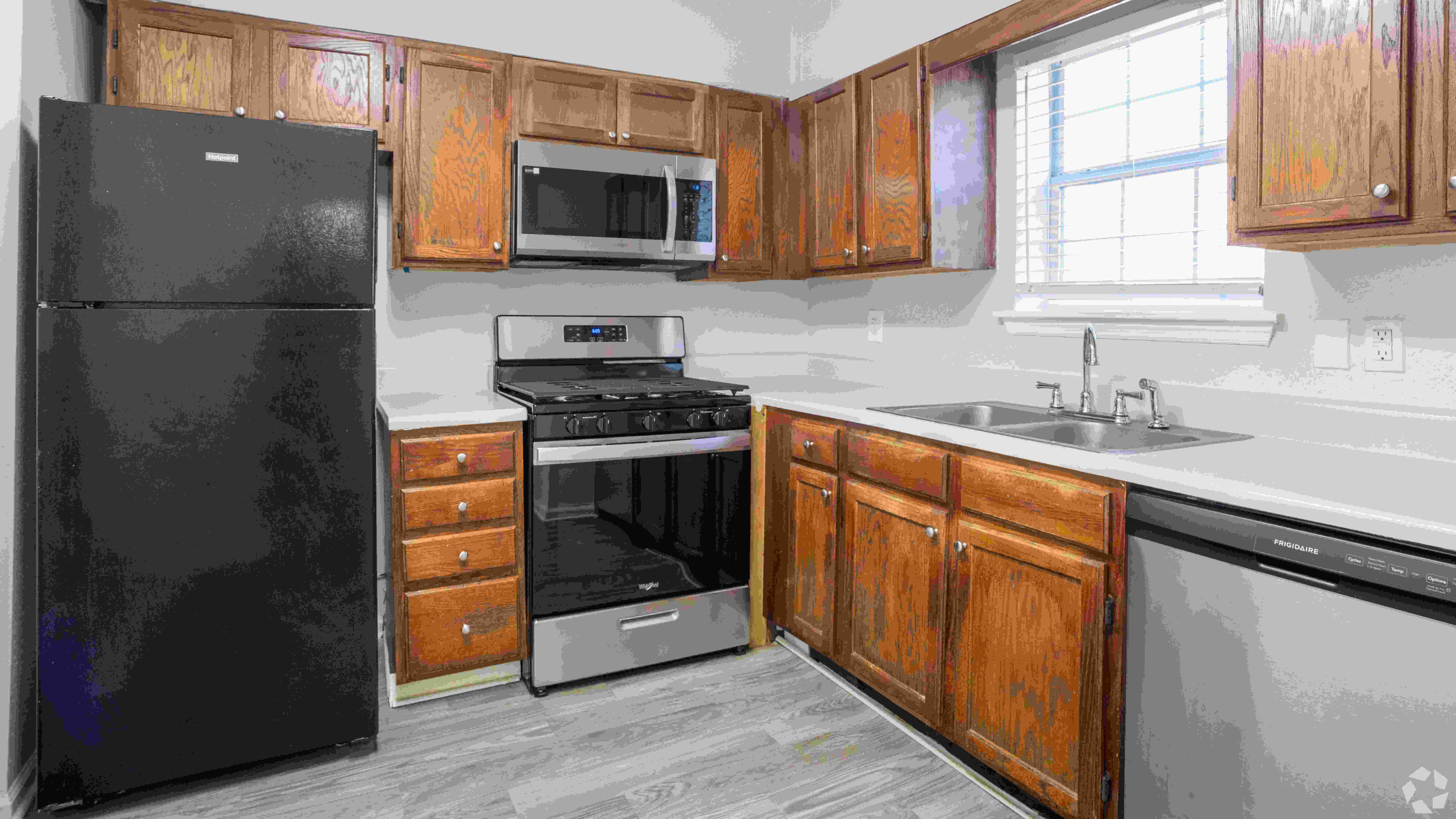 Spacious kitchen in The Roswell floor plan featuring modern appliances, ample cabinetry, and a double sink for convenience.