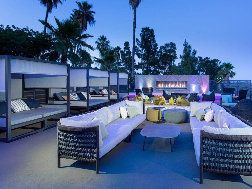 Outdoor lounge with cabanas and fireplace