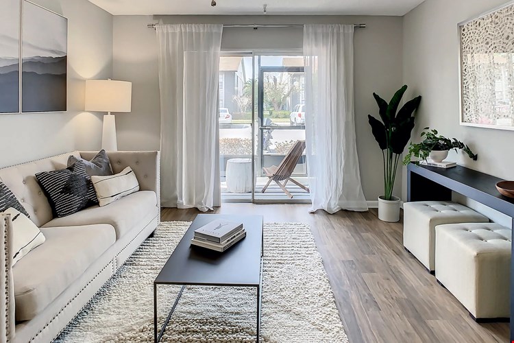 Unwind in our spacious living rooms with ceiling fans and private patio access.