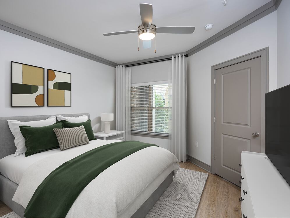 Bedroom with hard-surface vinyl plank flooring and ceiling fan