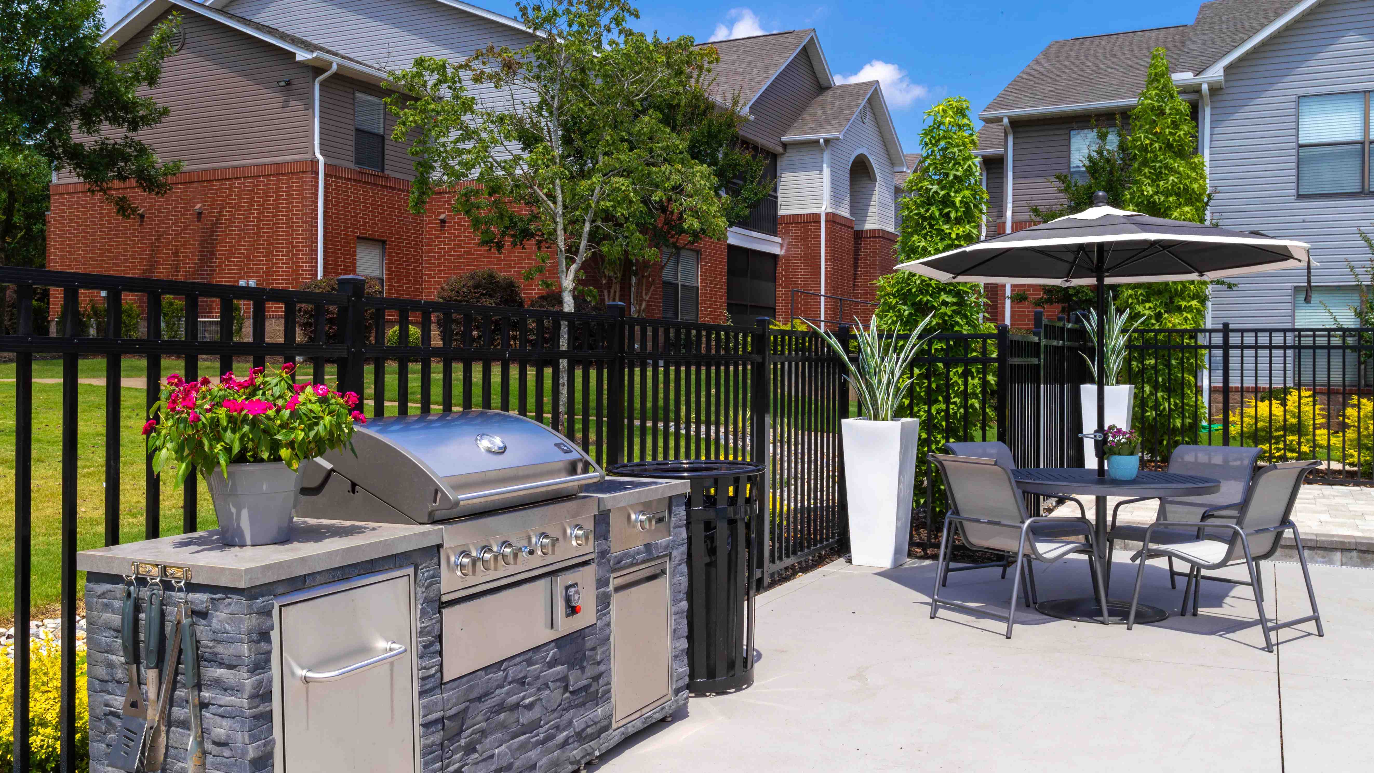Enjoy a delightful barbecue and outdoor dining experience at our outdoor kitchen featuring a modern grill and comfortable seating.