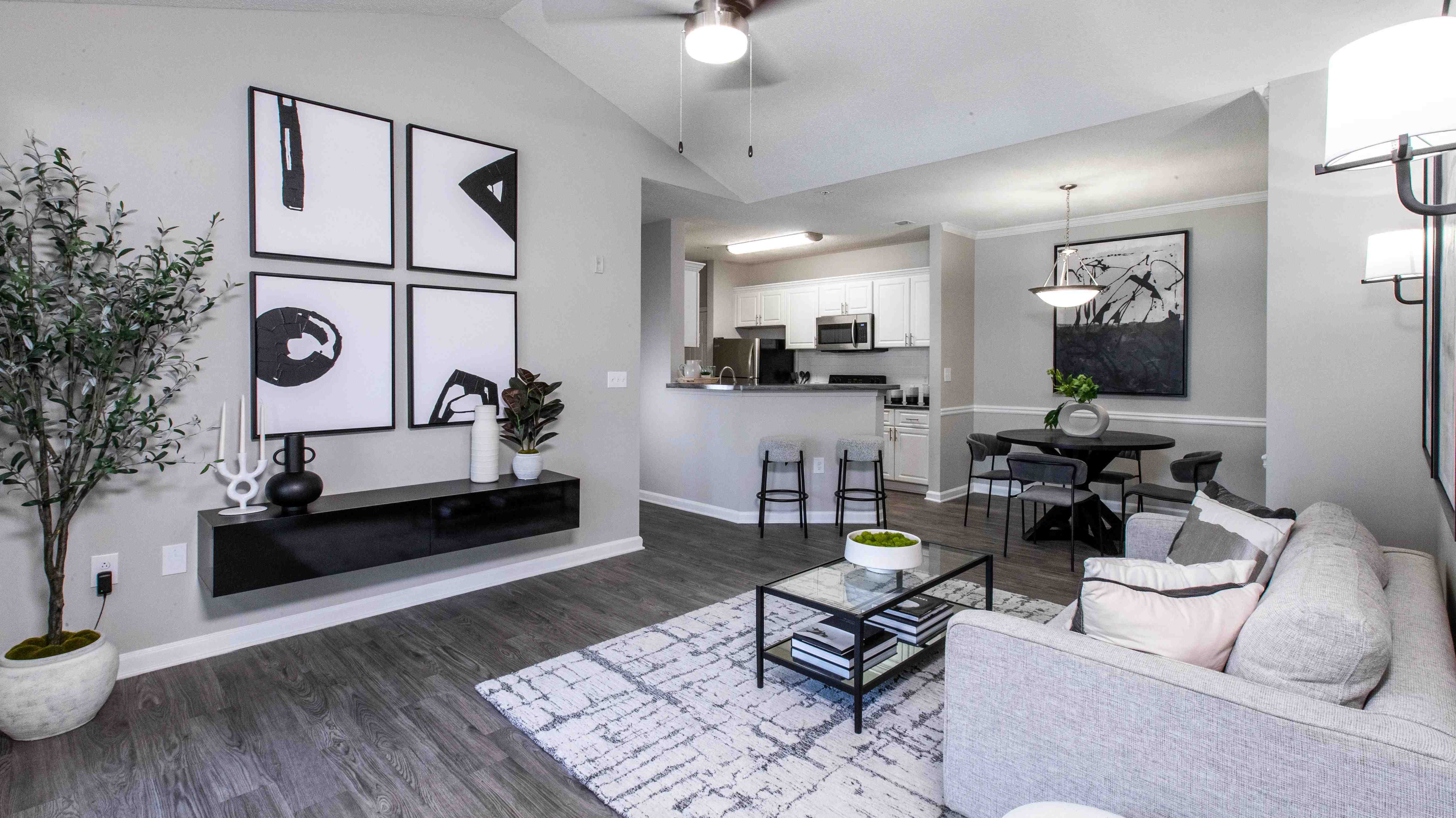 Delight in the luxury of our expansive living rooms featuring rich wood-style flooring and modern ceiling fans with lights.