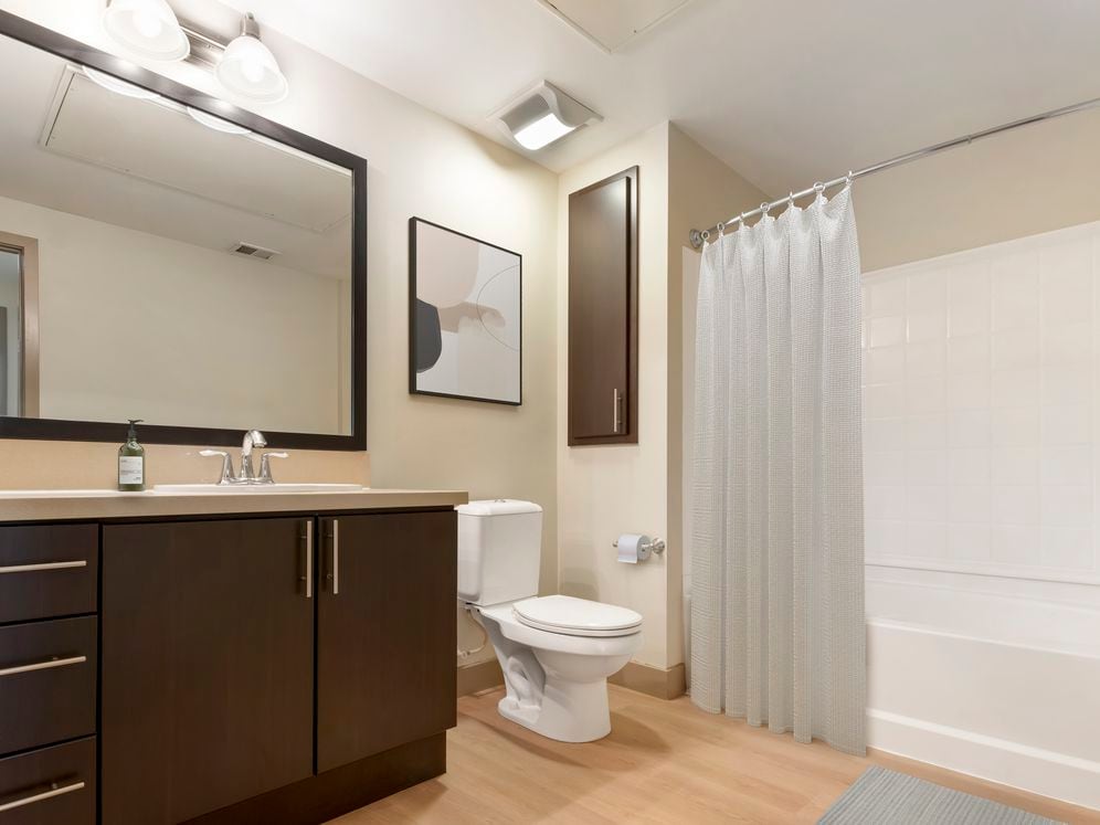 Classic Collection II bath with beige quartz countertop, espresso cabinetry, and hard surface flooring