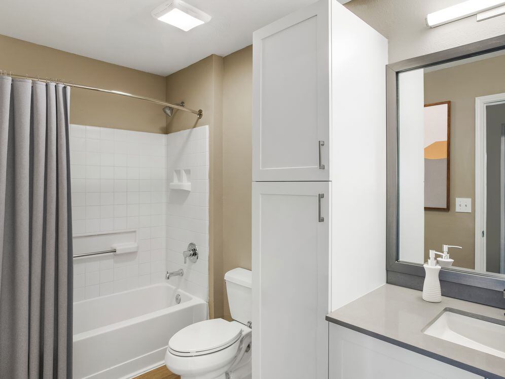 Upgrade Scheme II bath with white shaker cabinetry, grey quartz countertops, and hard surface flooring