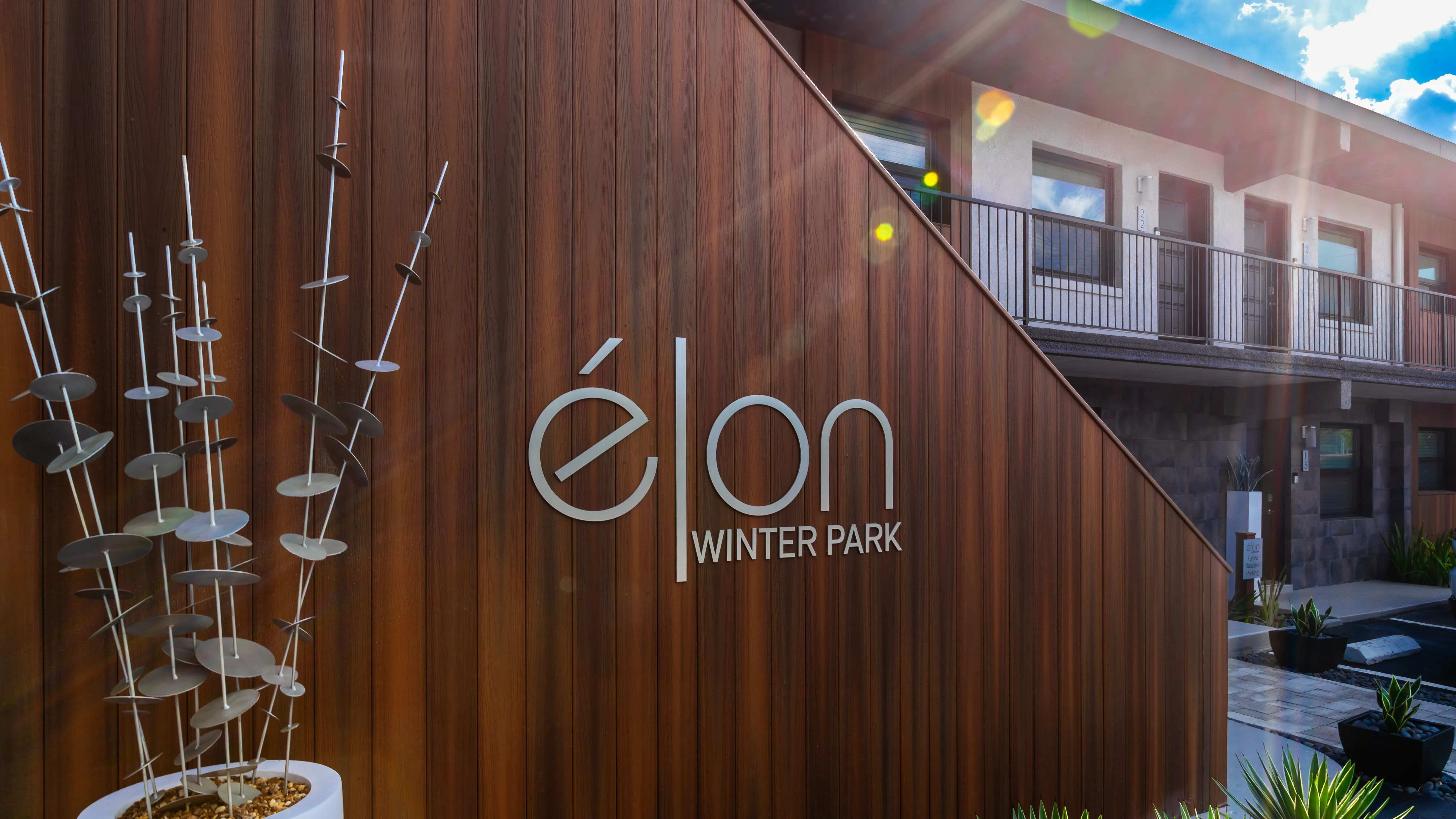 The stylish exterior signage at Elon Winter Park Apartments embodies modern sophistication, complementing the community's contemporary design and inviting atmosphere. 