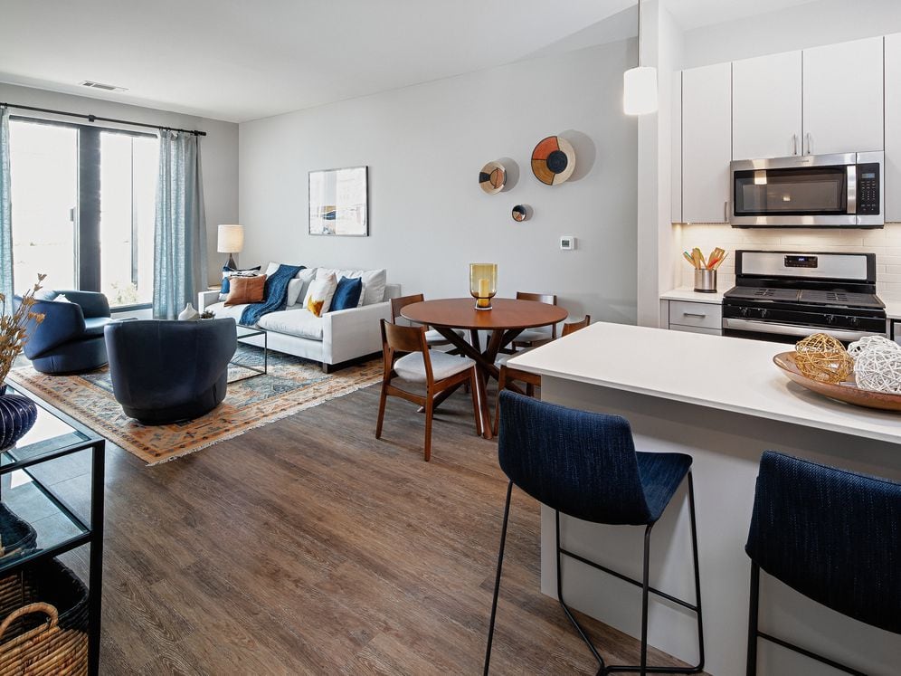 Base Scheme apartment home kitchen, dining, and living areas with hard surface flooring