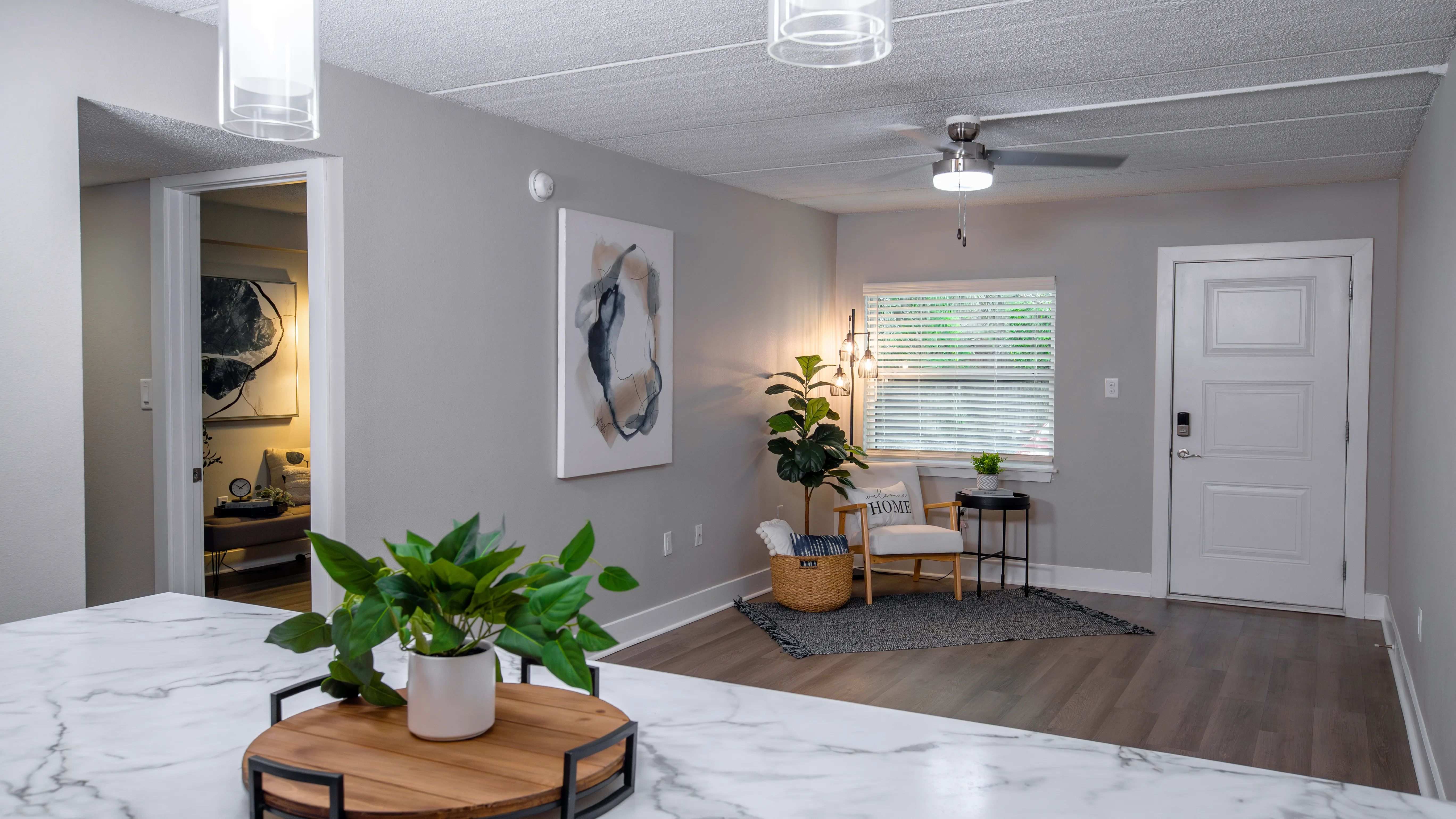 Welcome to your cozy and stylish living room at Elon Winter Park Apartments, offering a cozy atmosphere with modern finishes, stylish lighting, and plenty of natural light. A perfect space for relaxation and everyday comfort. 