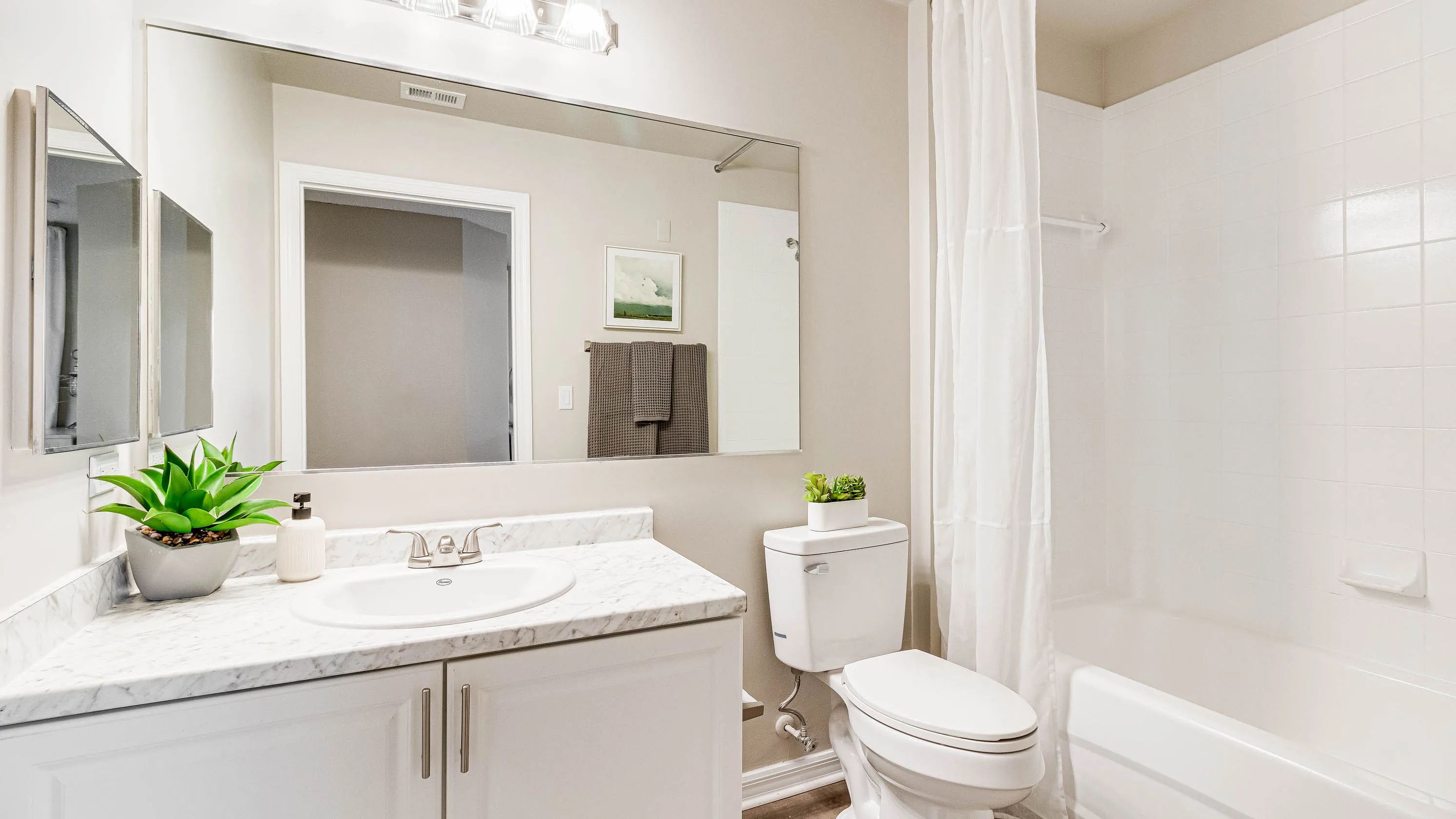 Our primary bathrooms feature oversized mirrors and optimized storage.