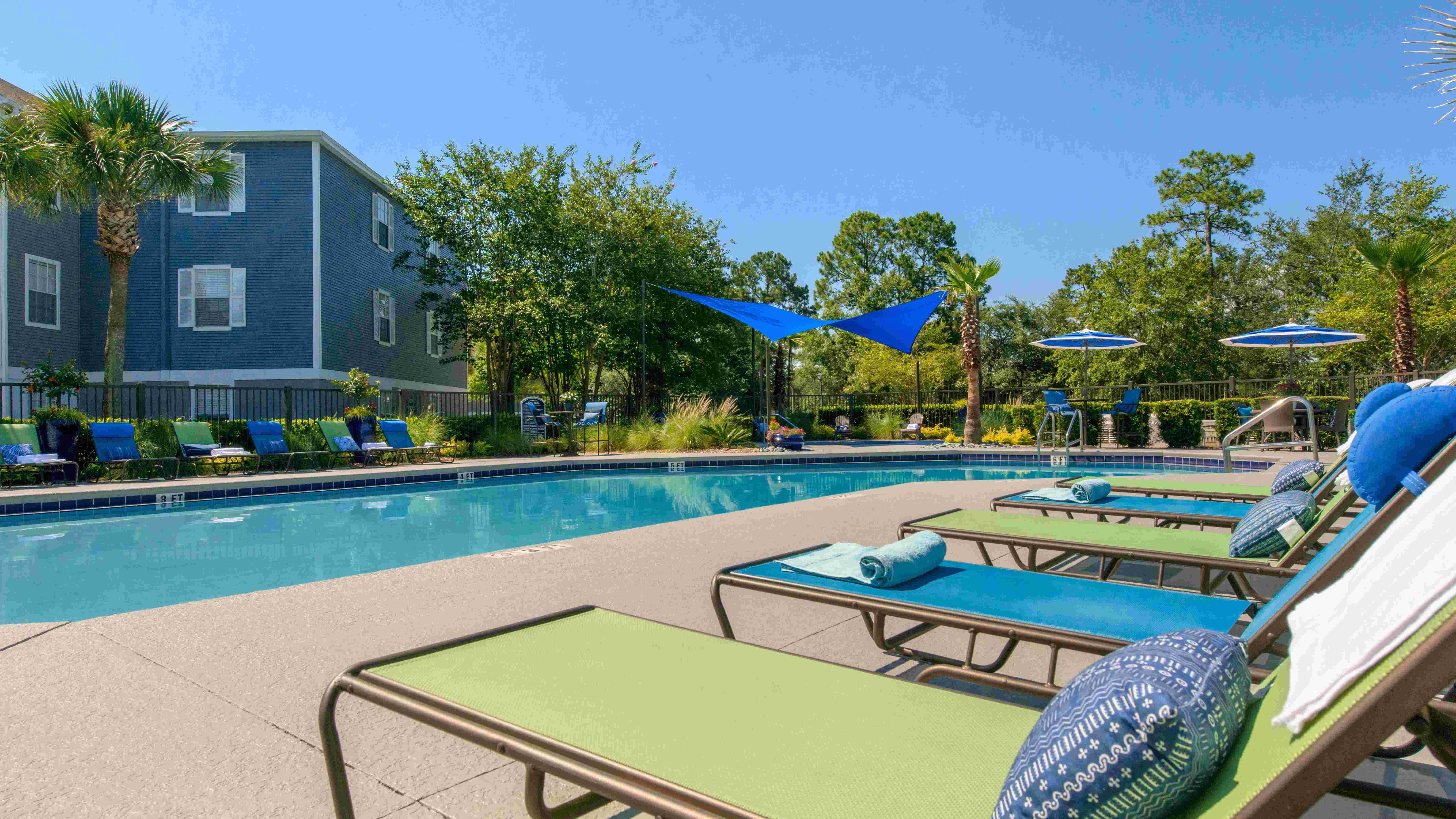 Indulge in serenity at our lakeside pool loungers. Comfort and beauty intertwine in this magical setting.