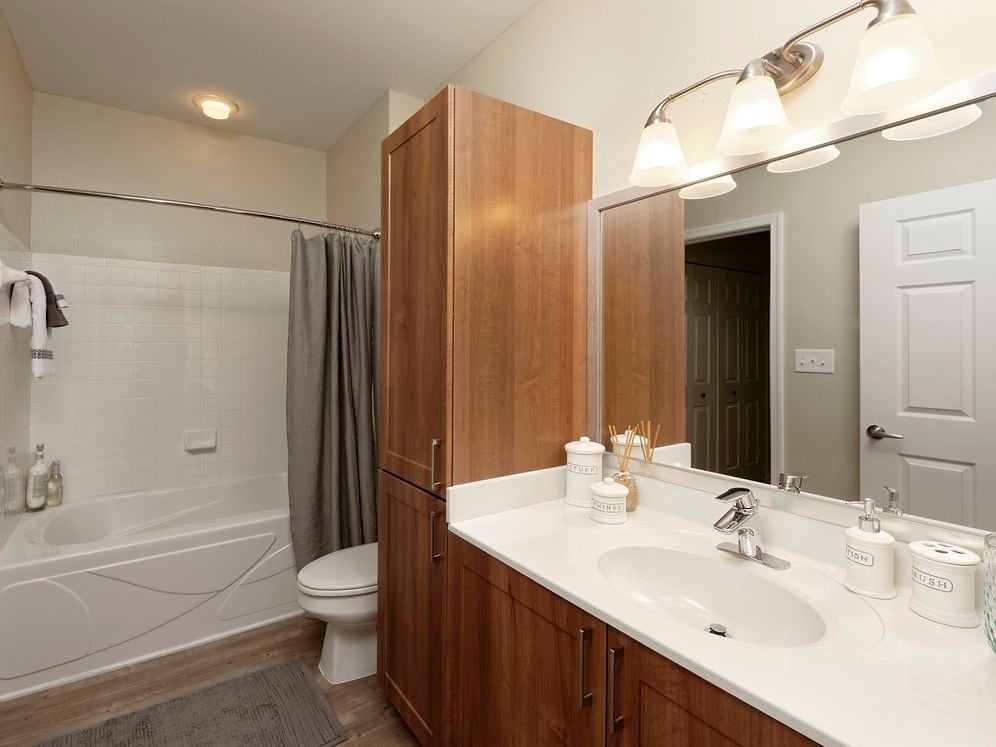 Hazelnut Finish Package bath with white countertop and hard surface flooring