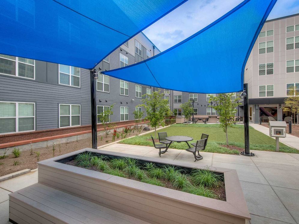 Main courtyard with seating areas and shades