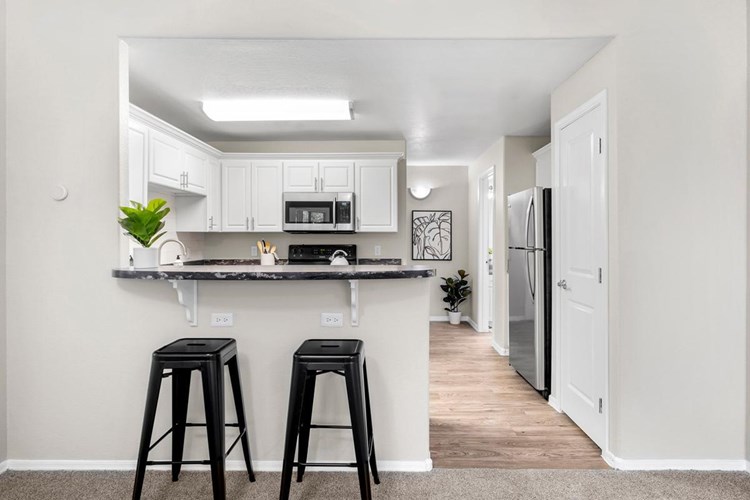 Kitchens feature a breakfast bar overlooking the living area, as well as a dishwasher!