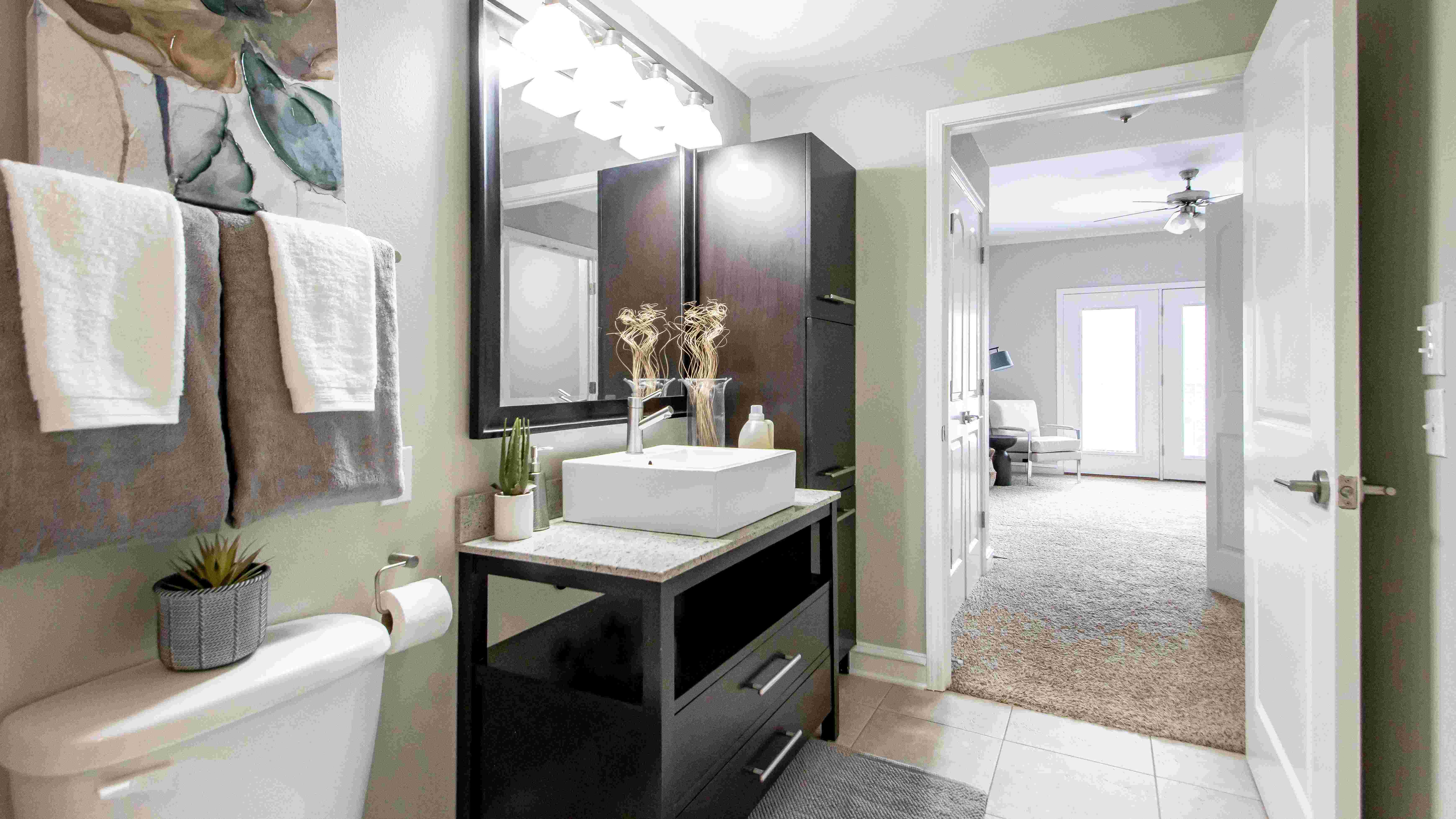 Immerse yourself in opulence seamlessly flowing from your regal bedroom to the opulent master bath, boasting lavish design with granite countertops and sumptuous cabinet space, embodying sophistication and luxury.