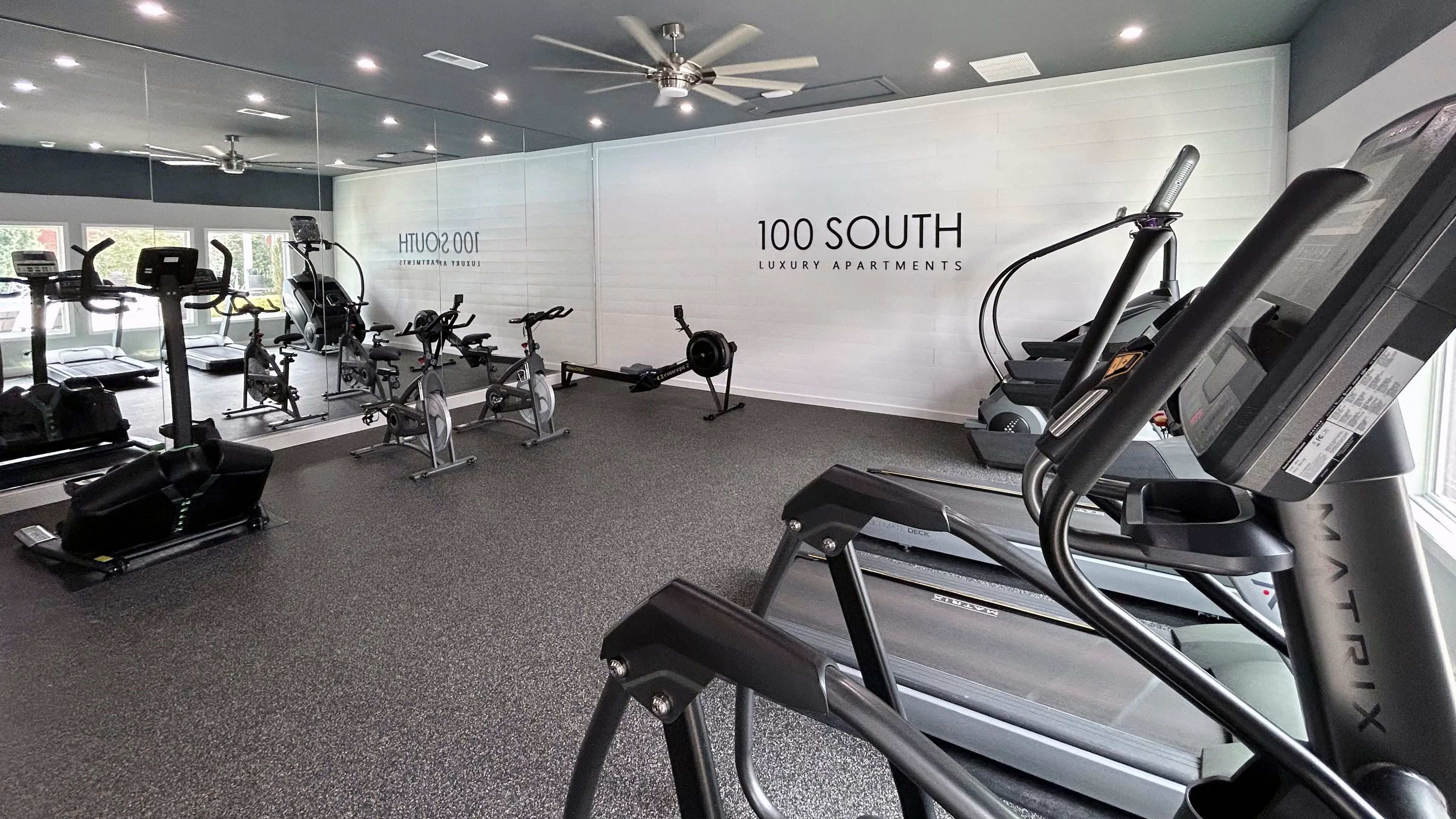 Experience a sleek and spacious workout environment at 100 South Luxury Apartments, complete with ellipticals, treadmills, rowing machines, and spin bikes.