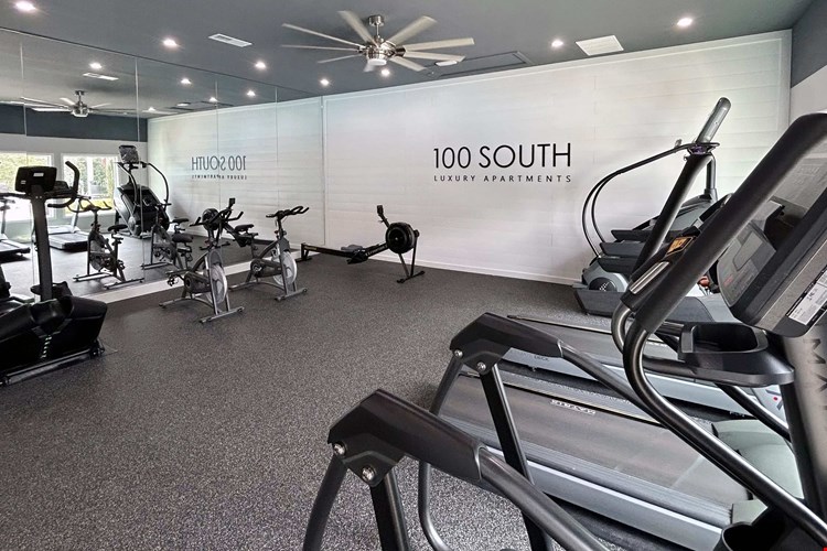 Experience a sleek and spacious workout environment at 100 South Luxury Apartments, complete with ellipticals, treadmills, rowing machines, and spin bikes.