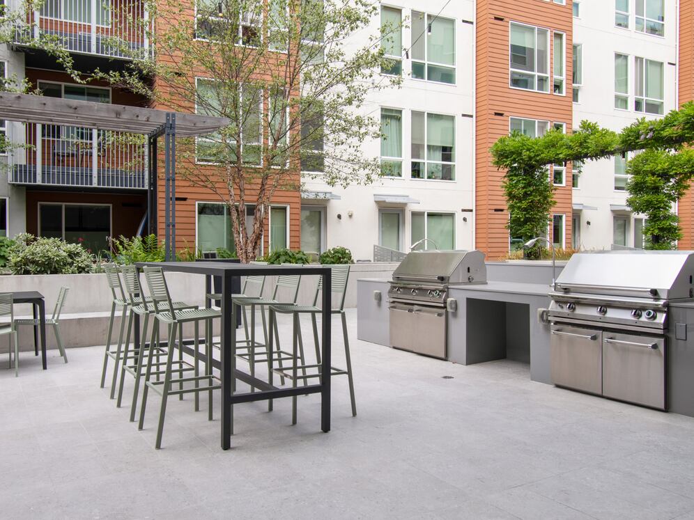 Outdoor resident lounge with common area seating and barbecue grills