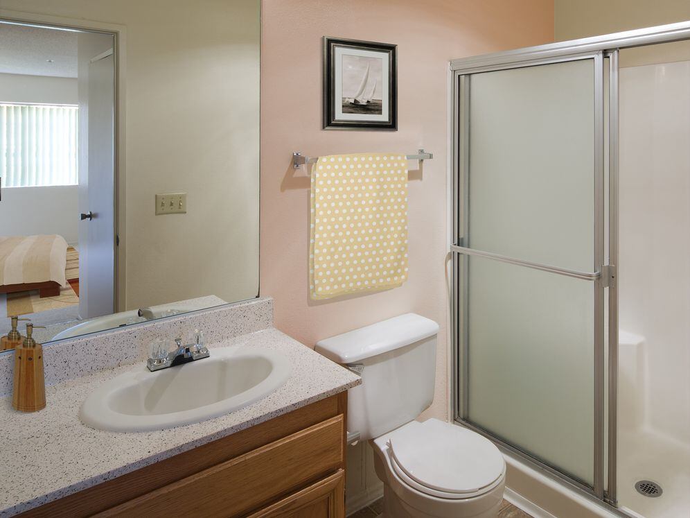 Classic Package bath with oak cabinetry, beige speckled laminate countertops, and tile flooring