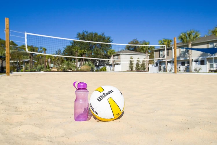 Get in a game at our sand volleyball court.